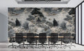 A cozy office featuring a charcoal river landscape wallpaper mural behind a dark wood desk.