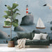 An entryway wall decorated with a peaceful ocean landscape mural featuring birds and sailing boats.