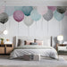Bedroom featuring whimsical balloon wallpaper mural with soft pastel color tones