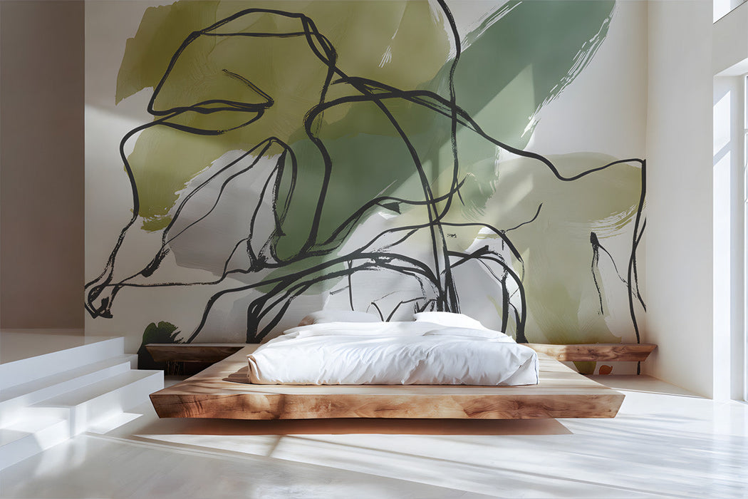 A bright, airy bedroom wall featuring abstract botanical line art wallpaper behind a minimalist wooden desk.
