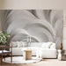 Modern living room with organic fluid swirl wallpaper behind a minimalist charcoal sofa