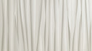 Abstract vertical paper folds in soft off-white and cream tones creating a minimalist layered architectural look
