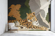 Leopard mural installed in a sophisticated reading nook with leather furniture and wood accents