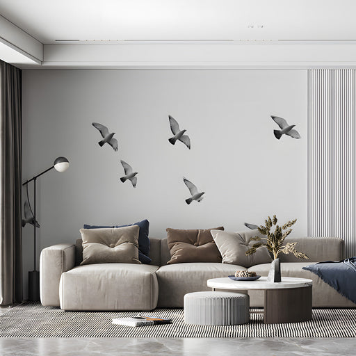 A minimalist home office space with bird mural wallpaper creating a calm, open atmosphere.