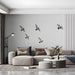 A minimalist home office space with bird mural wallpaper creating a calm, open atmosphere.