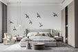 A clean, modern living room featuring the flying birds mural on the main accent wall.