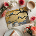 Dining room wall decorated with a sophisticated gilded landscape mural and azure bird motifs