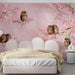 A calm bedroom interior with a cherry blossom and owl wallpaper accent wall.