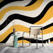 Modern study featuring a wavy ochre and charcoal mural behind a minimalist beige sofa.