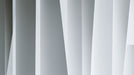 Abstract wallpaper pattern with sharp vertical light gray and charcoal geometric panels