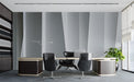 Modern office space with a geometric vertical line wallpaper mural behind a desk