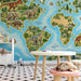 A playroom featuring a colorful educational world map mural with dinosaurs, set behind a neutral wooden desk.
