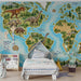 A child's bedroom featuring a mosaic dinosaur world map mural on the main wall with minimalist white furniture.