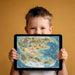 A playful child's bedroom with a Pangea dinosaur world map mural on the main wall above a wooden bed frame.