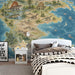 A sophisticated home office space showing a vintage-style dinosaur map wallpaper as a creative, scholarly accent wall.