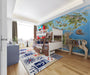 A kid’s bedroom featuring a large dinosaur world map mural on the main wall with wooden furniture and soft lighting.
