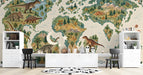 Dinosaur world map mural installed in a child's bedroom with natural wood furniture and neutral bedding.