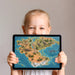 A bright playroom interior featuring a dinosaur land map mural on the main accent wall.