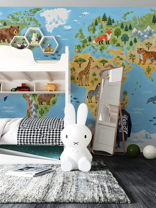 A child's bedroom wall featuring a vibrant world map wallpaper with animals, paired with light wooden furniture.