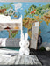 A child's bedroom wall featuring a vibrant world map wallpaper with animals, paired with light wooden furniture.