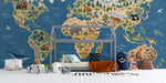 The world map mural installed on a large bedroom wall, featuring wooden bed frame and earthy decor elements.