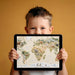 A creative playroom wall covered in a detailed animal world map mural wallpaper design.
