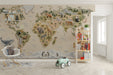 A bright nursery room featuring an illustrated world map wall mural with animals for kids.