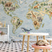 A playroom for children with a world map wall covering featuring animals from around the globe.