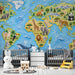 World map mural with wildlife motifs displayed in a vibrant children's study area