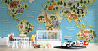 Knitted world map wall mural in a colorful nursery room with wooden crib