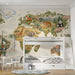 A bedroom area with an illustrated map of the world, educational decor, and natural wood toys.