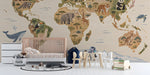 Whimsical world map mural installed in a bright nursery with light wooden crib and soft neutral decor.