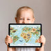 A colorful playroom space with the world map mural and floor cushions for children to learn and read.