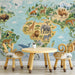 A cozy playroom corner featuring a world map wall mural as a backdrop to a wooden desk.
