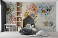 Whimsical world map mural installed in a colorful boy's room with wooden furniture.