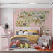 Global animal map wallpaper featuring a soft pink background in a bedroom setting