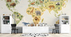 A nursery room wall featuring the world map mural with soft cream tones and illustrated animals.