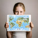 A creative playroom for kids decorated with a vibrant global map mural and colorful open shelving for toys.