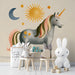 Themed wall art in a creative playroom featuring a mythical unicorn and celestial elements