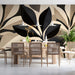 Modern dining room featuring a black and cream botanical leaf mural as a statement wall