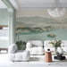The landscape mural installed in a bright living room, positioned behind a minimalist light oak desk.