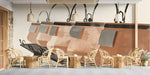 Restaurant wall featuring an artisanal ceramic pot mural above a rustic wooden countertop and open shelving.