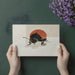A calm home office space with a ladybug mural behind a sleek wooden desk, creating a focused and serene environment.