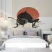 A stylish bedroom featuring a large ladybug wall mural with warm minimalist furniture and neutral decor.
