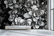 Modern hallway with black and white floral sketch wall behind a wooden desk