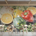 Kitchen wall with vibrant pepper and citrus watercolor mural, featuring matte black shelves