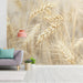 A bright study featuring a neutral wheat mural as an elegant accent wall behind a rustic wooden table.