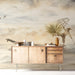 Bedroom with a serene fisherman watercolor mural behind a low beige sofa