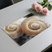 Coastal bedroom featuring a large scale seashell mural above a neutral upholstered headboard