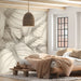 A serene bedroom with a large-scale botanical leaf mural behind a wooden headboard.
